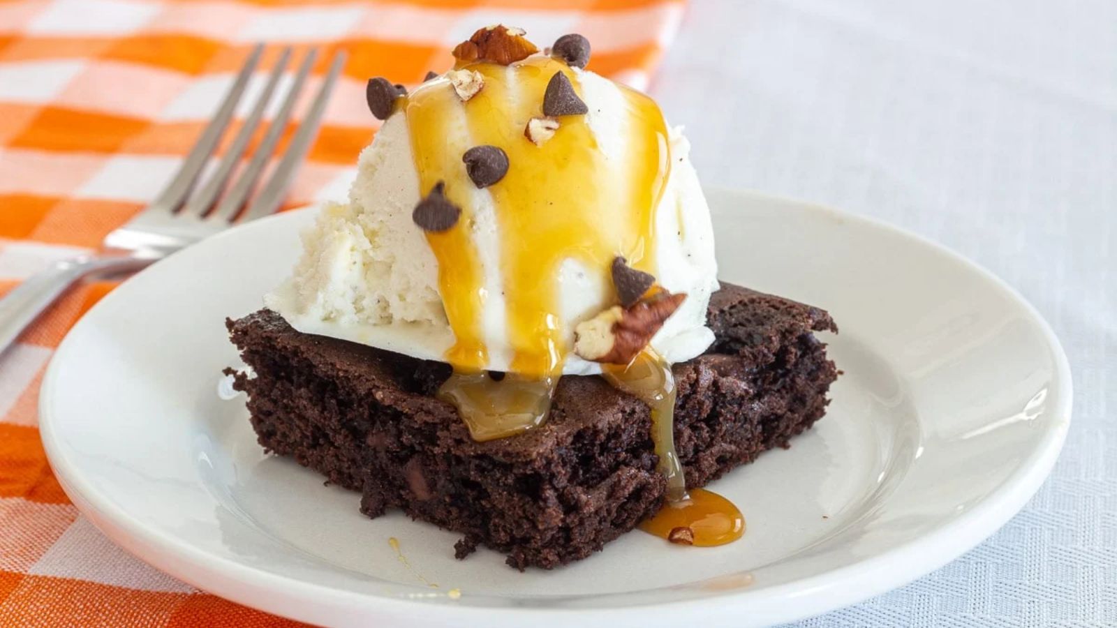 Chocolate dump cake with ice cream and chocolate chips.