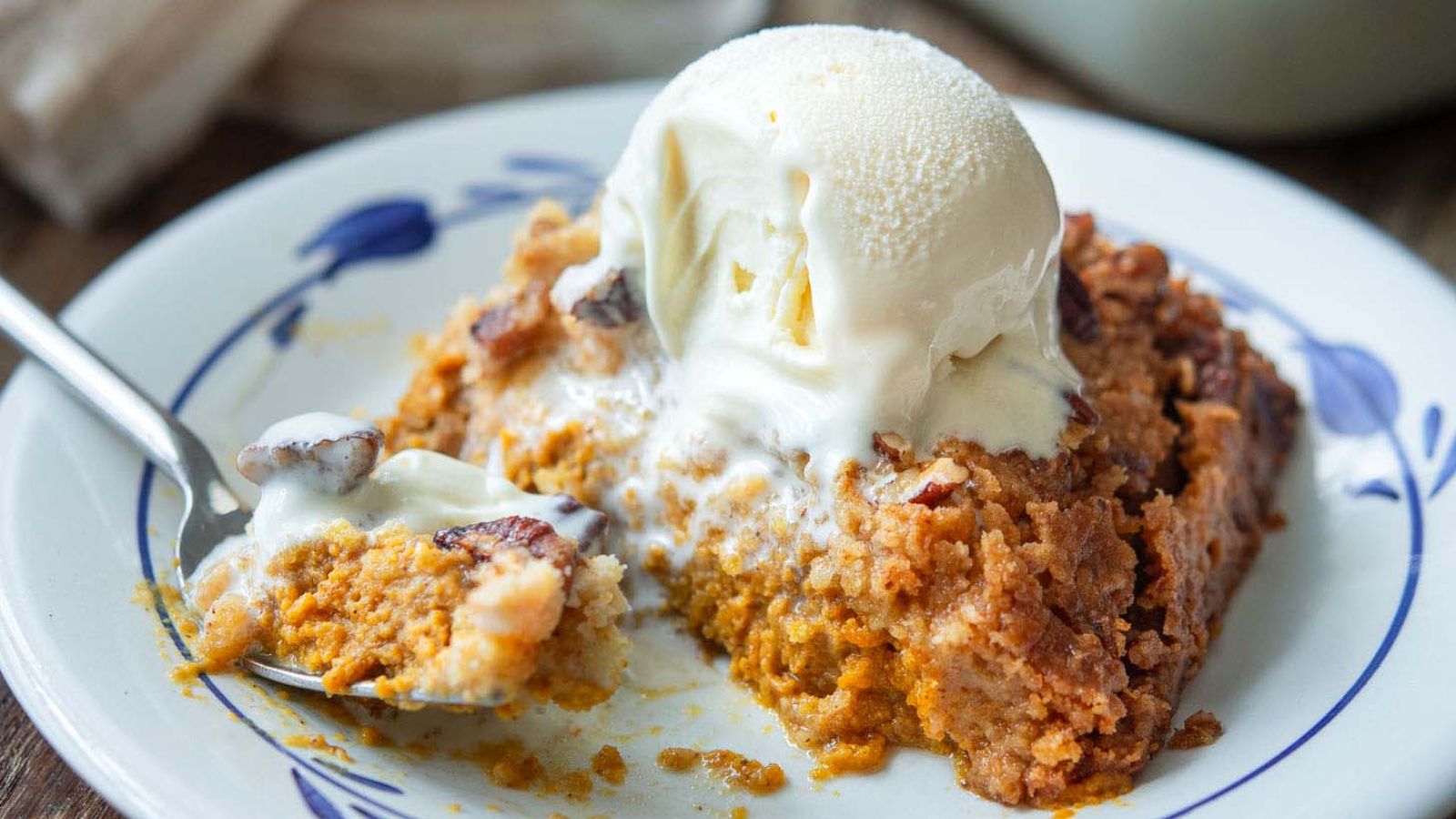 Pumpkin pie crunch cake with a scoop of ice cream on top.