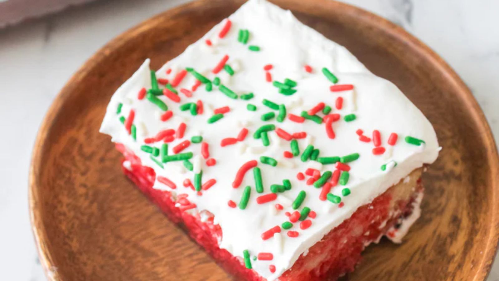 A slice of christmas poke cake.