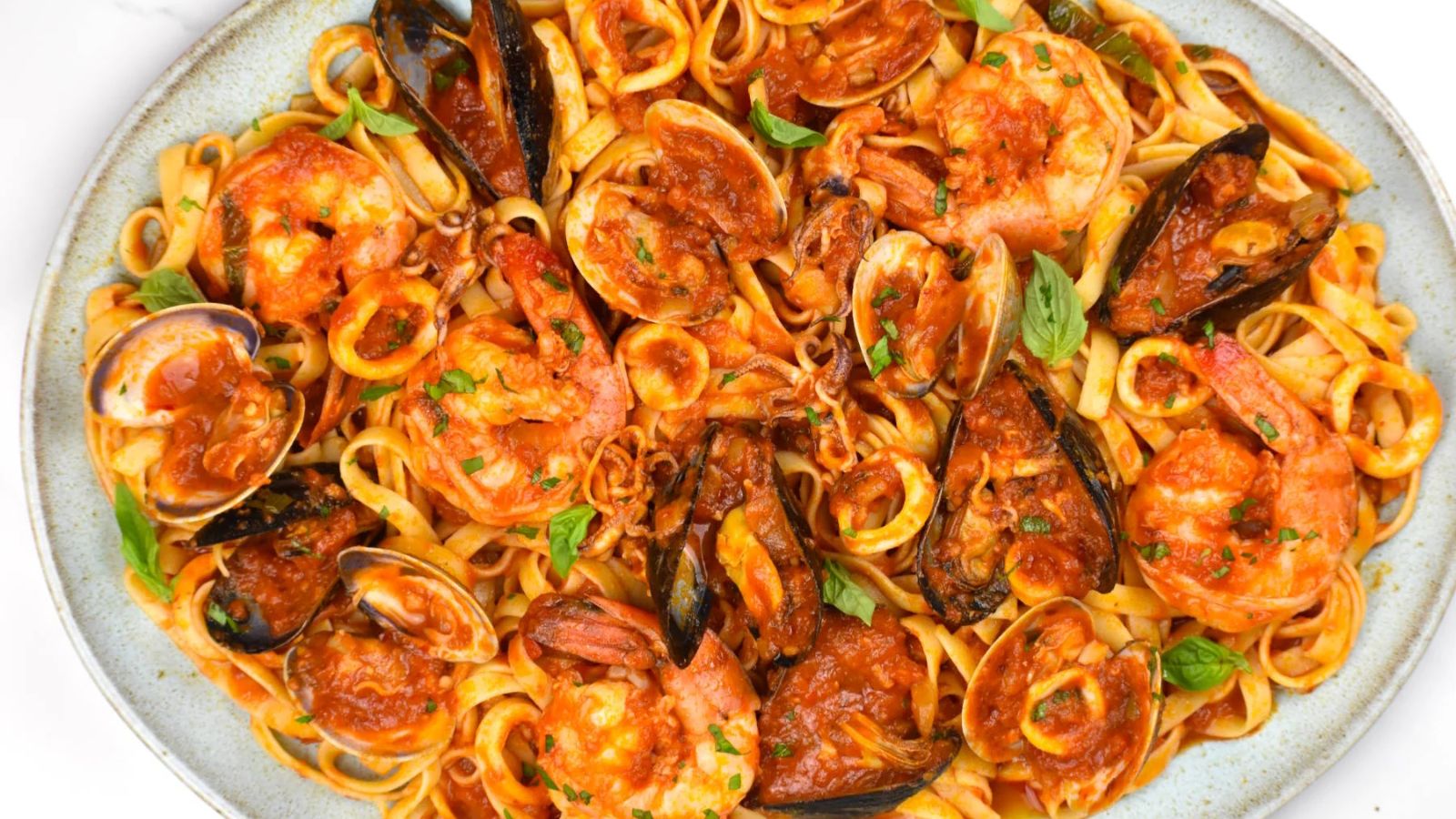 pasta with seafood on a large plate.