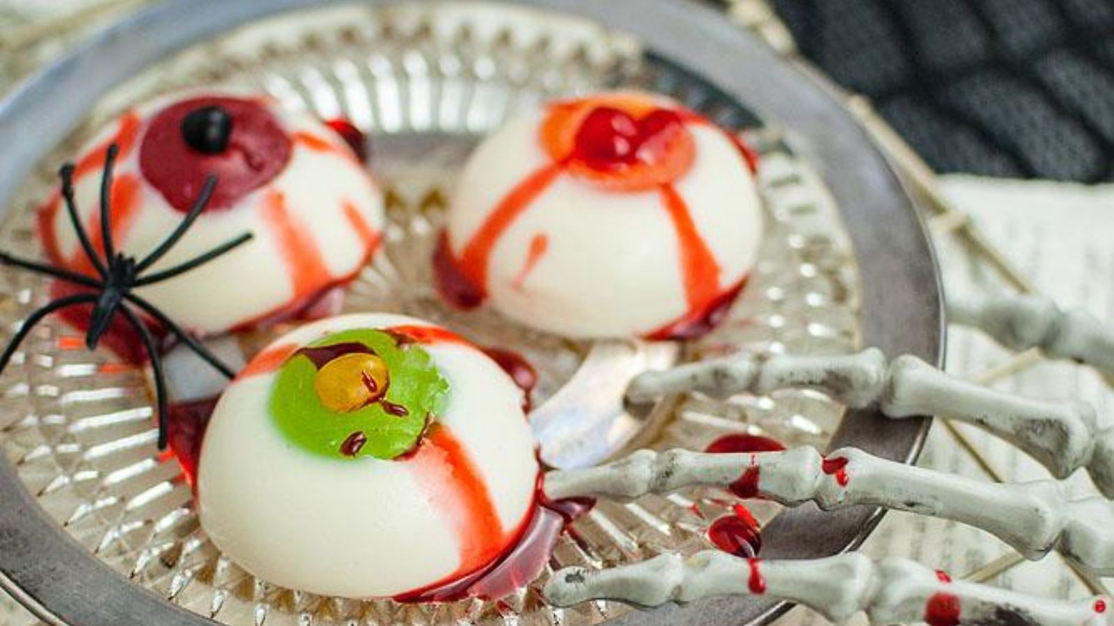 Halloween panna cotta eyeballs with spider.