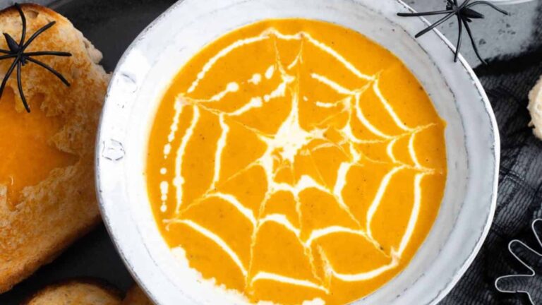 Pumpkin soup with spider web design.