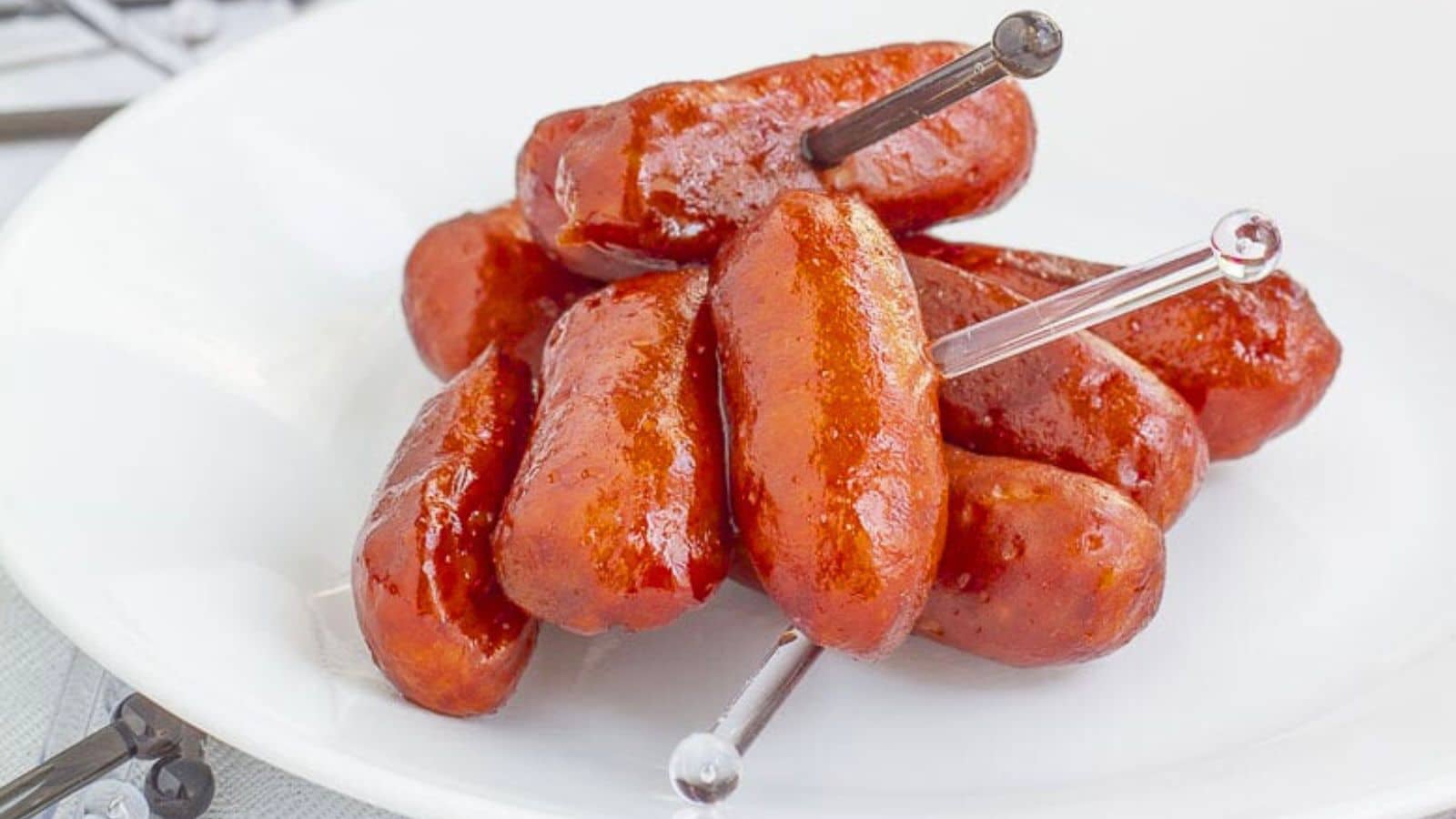 Mini hot dogs on small skewers.