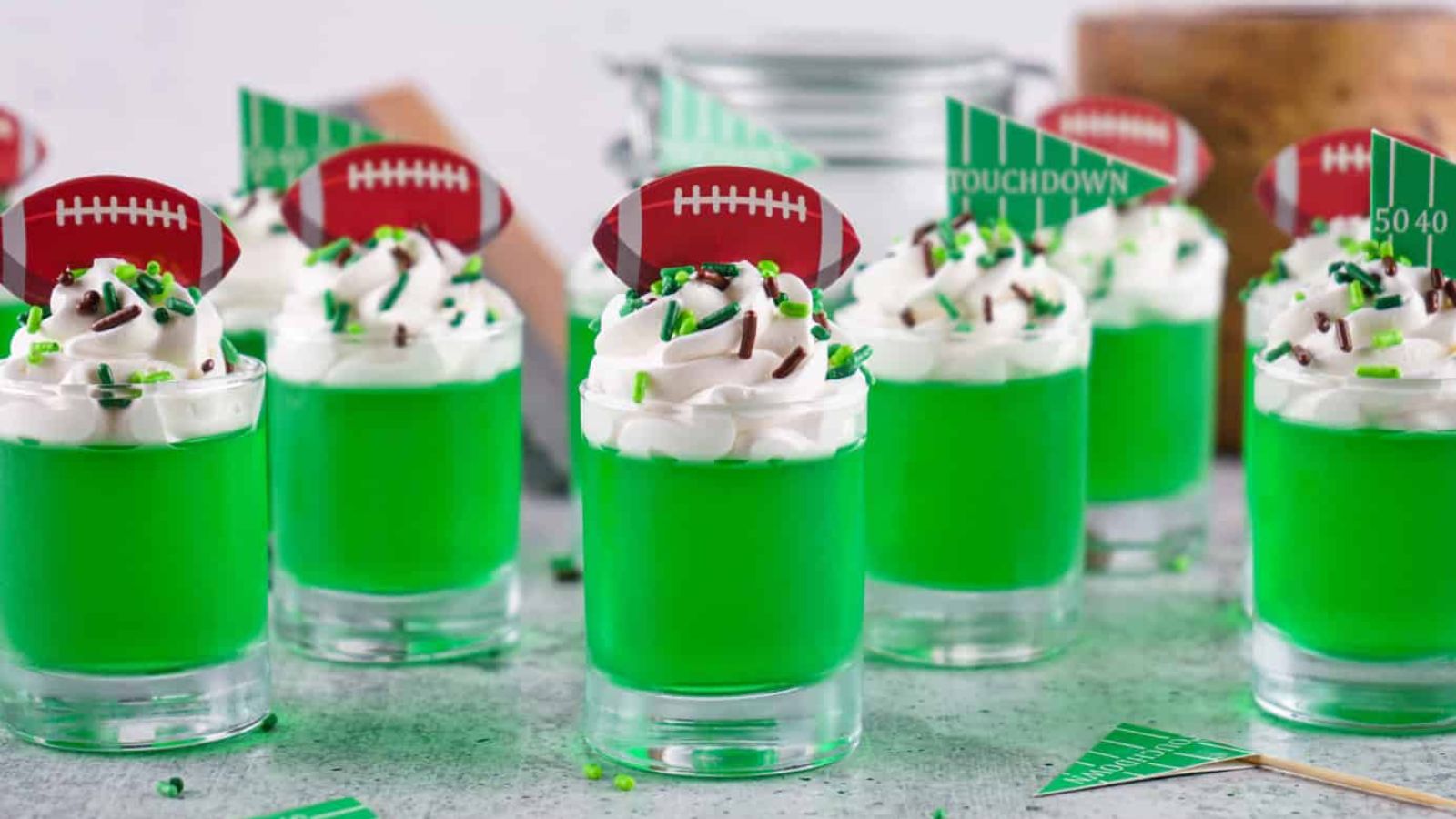 Lime green jello shots in glasses.