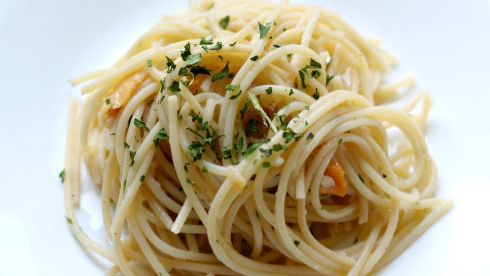 Pasta with parsley on top.