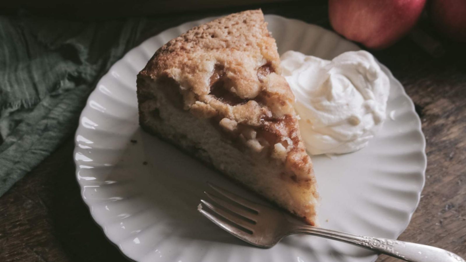A slice of cinnamon apple cake on a plate.
