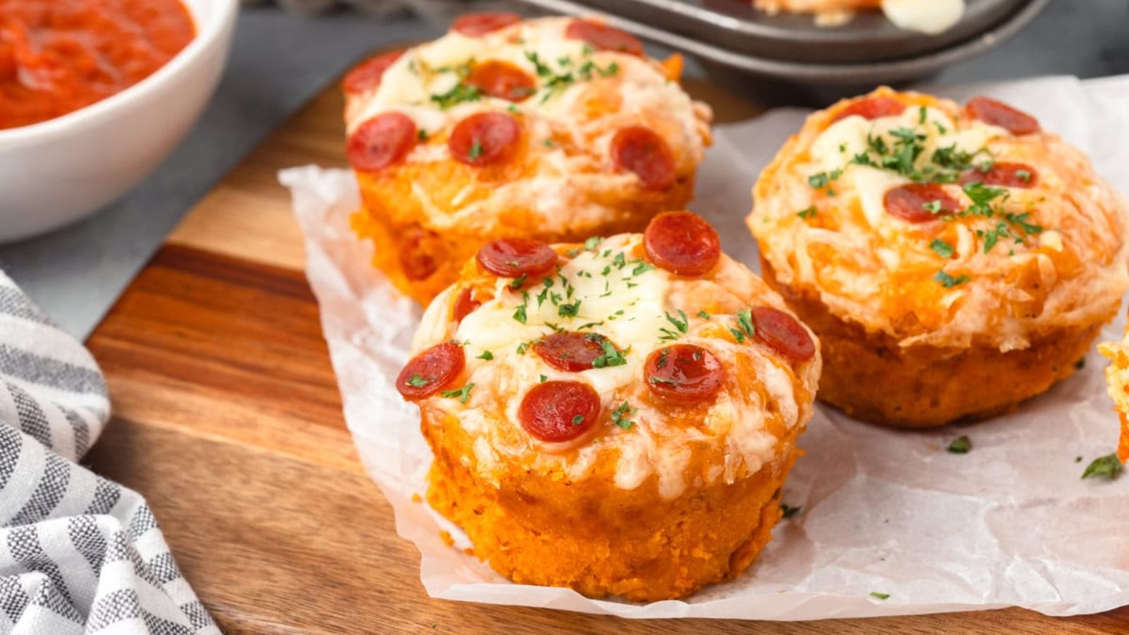 Pizza cupcakes on a wooden board.