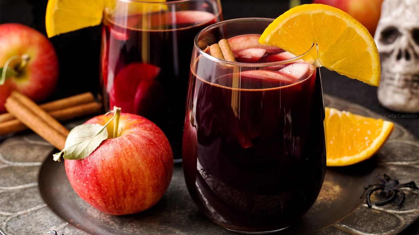 Red apple sangria with sliced orange.