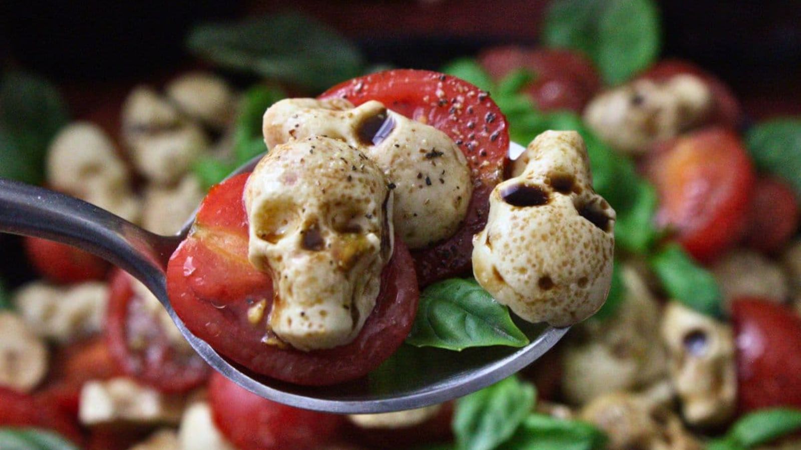 Skull caprese salad on a spoon.