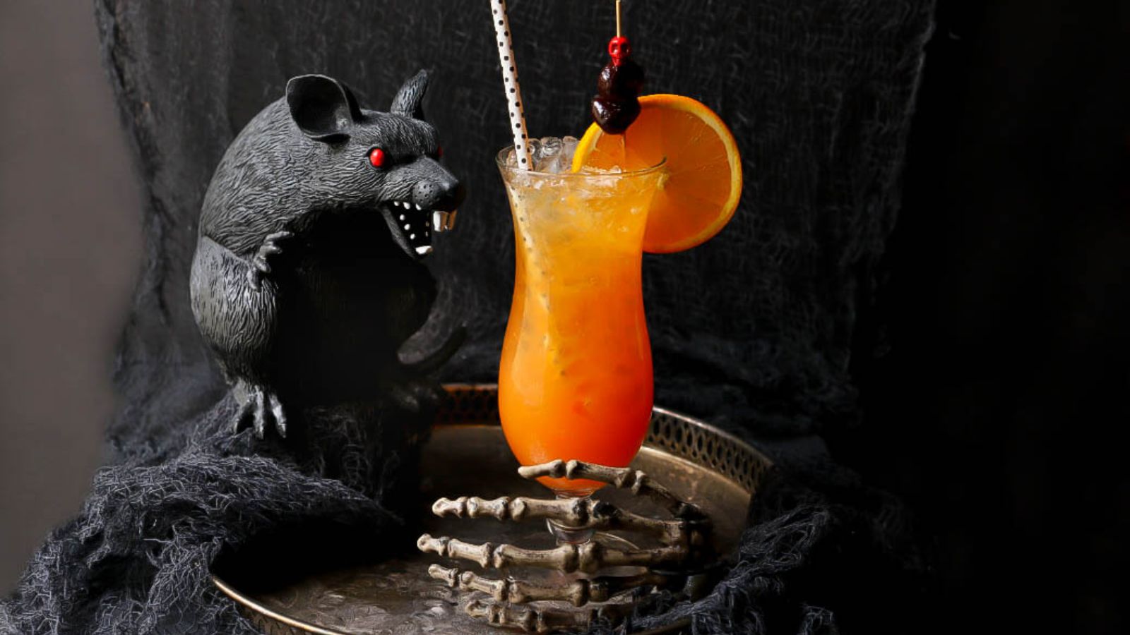 Cocktail with sliced orange on the side.