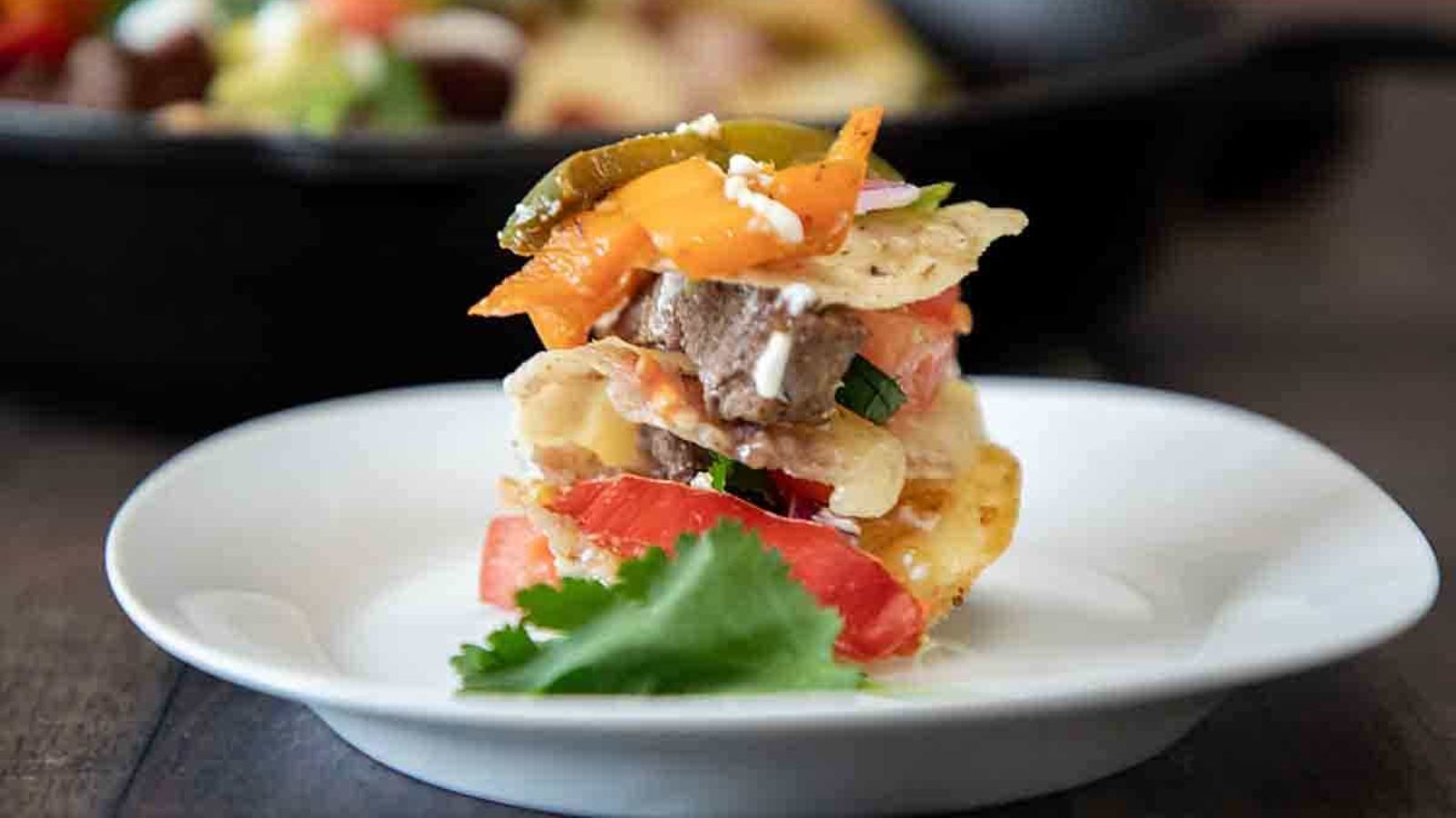 Nachos with veggies and steak.