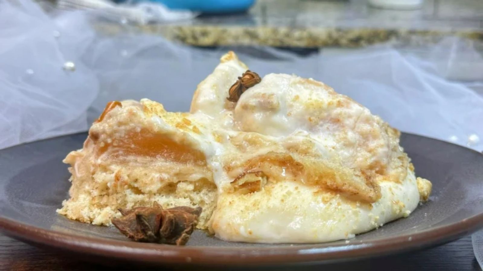 Upside down apple cheesecake on a plate.