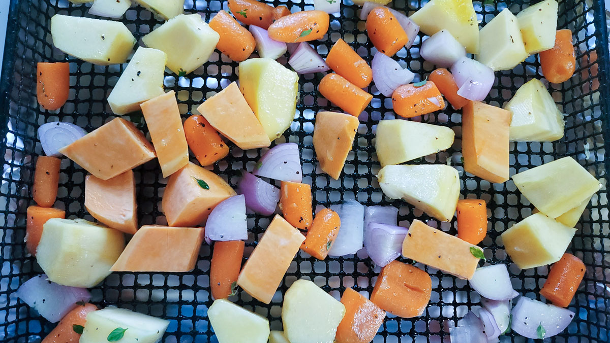 Vegetables in air fryer basket.
