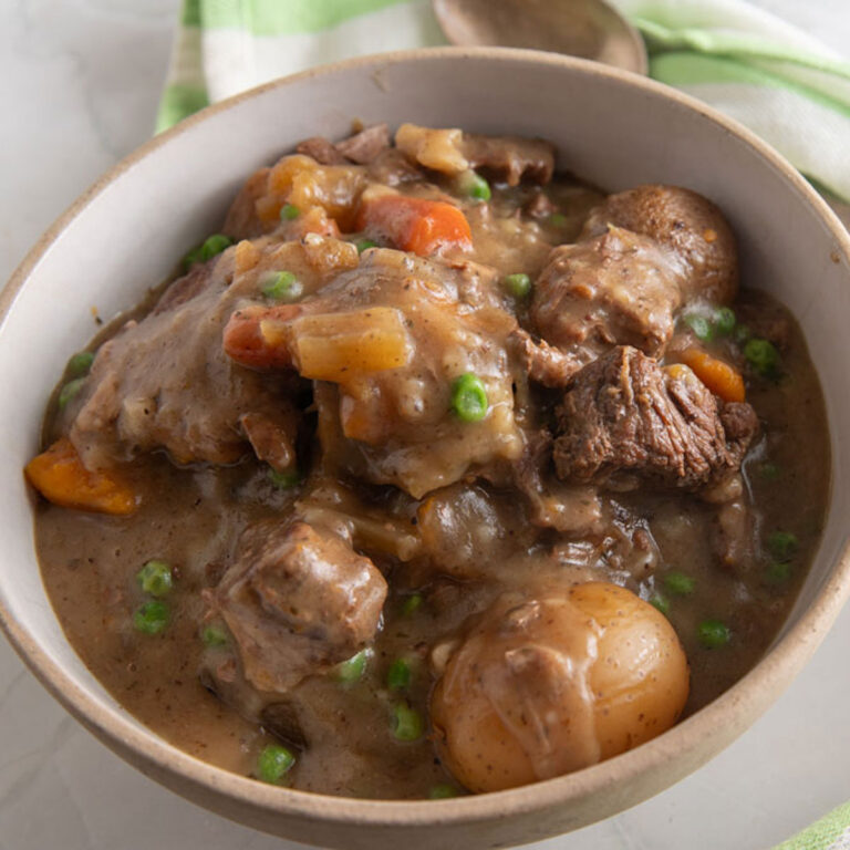 Large serving bowl filled with beef stew.