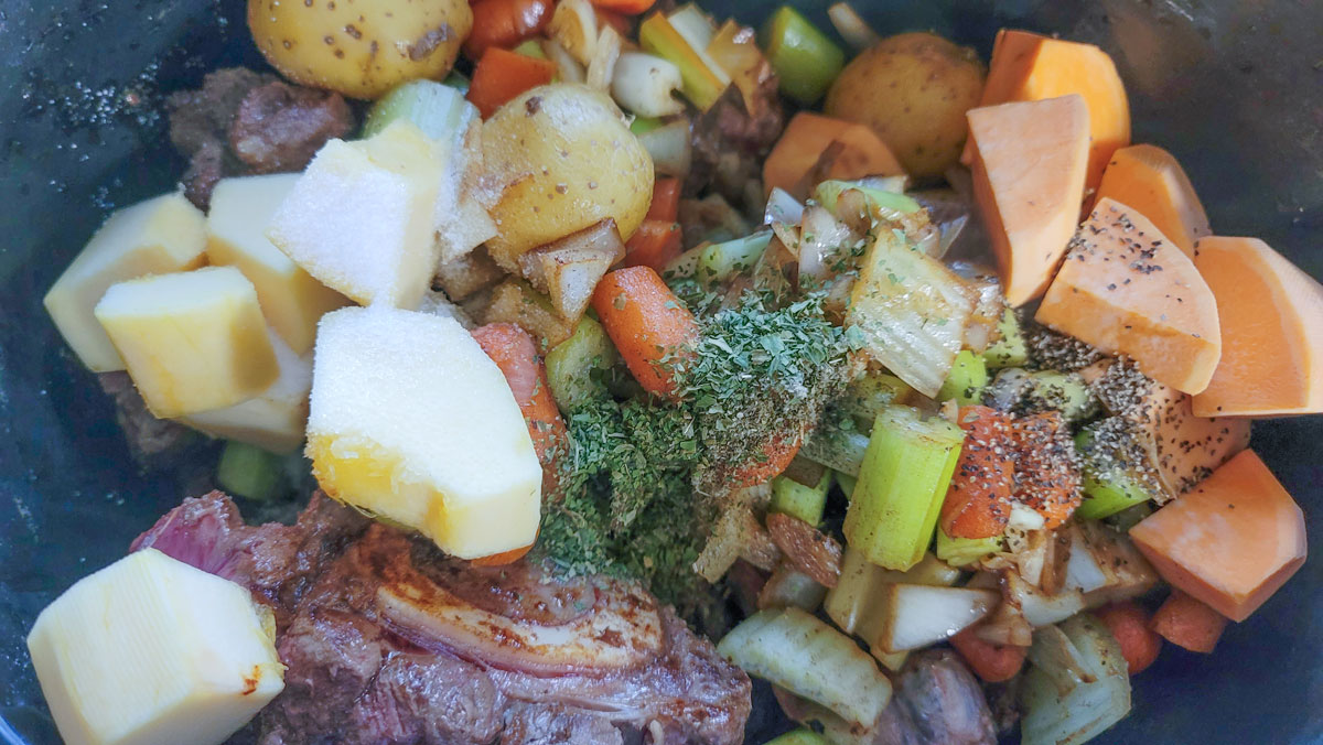 Herbs and seasonings added to the crockpot.
