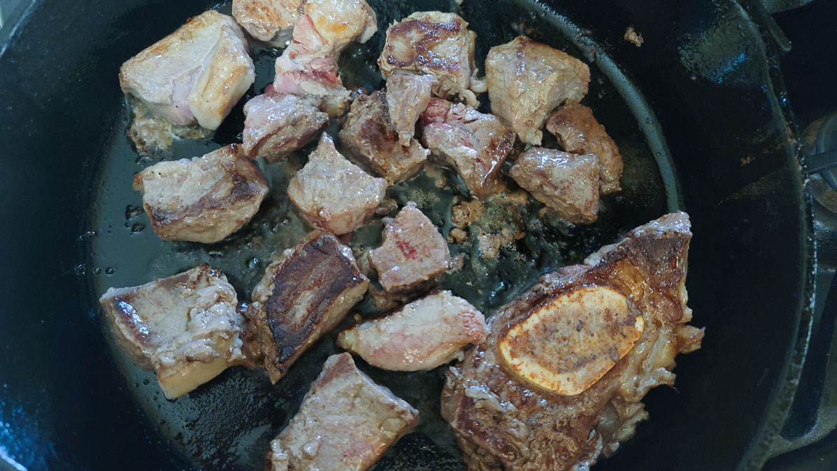 Meat flipped so the other side can brown.