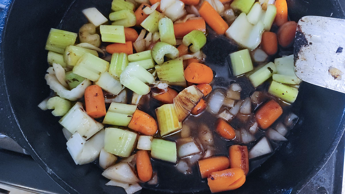 Skillet with wine and water added.