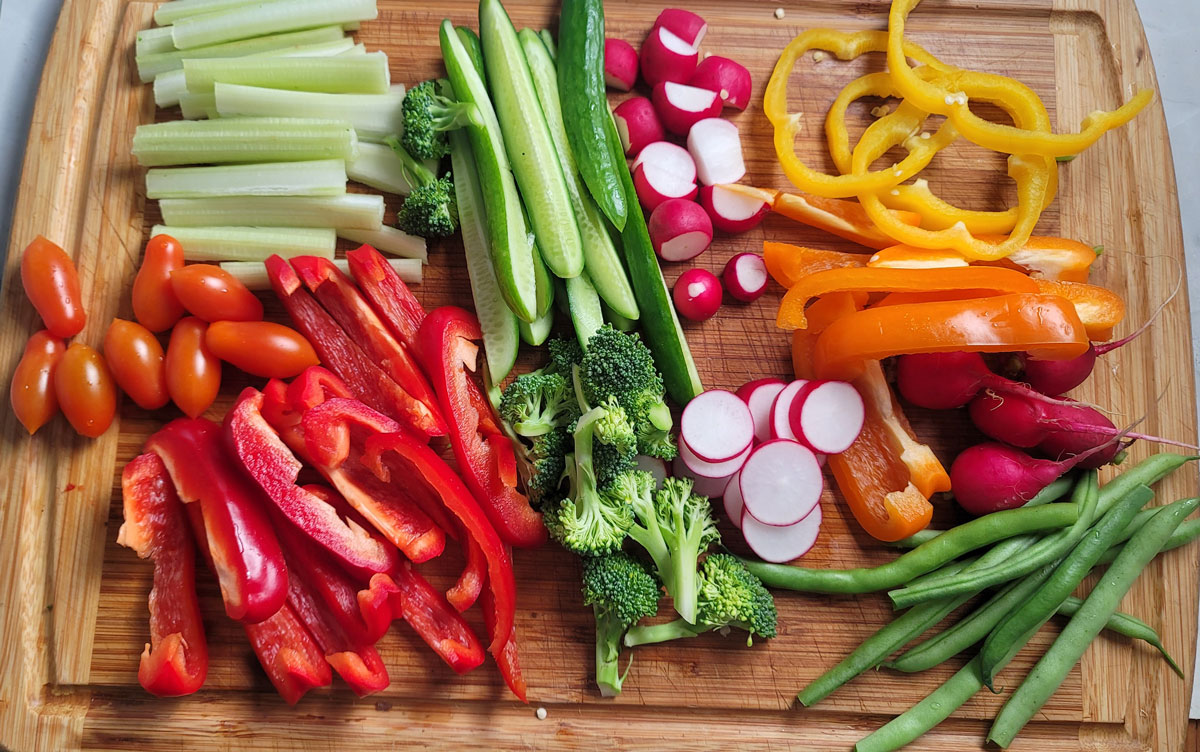 Prepared vegetables on a cutting board ready to be assembled on a platter.