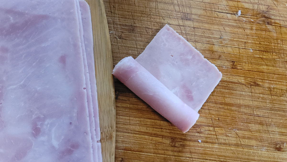 Meat in the process of rolling it into a log.