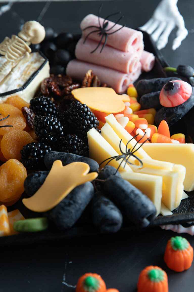 Close up of cheeses and grapes.