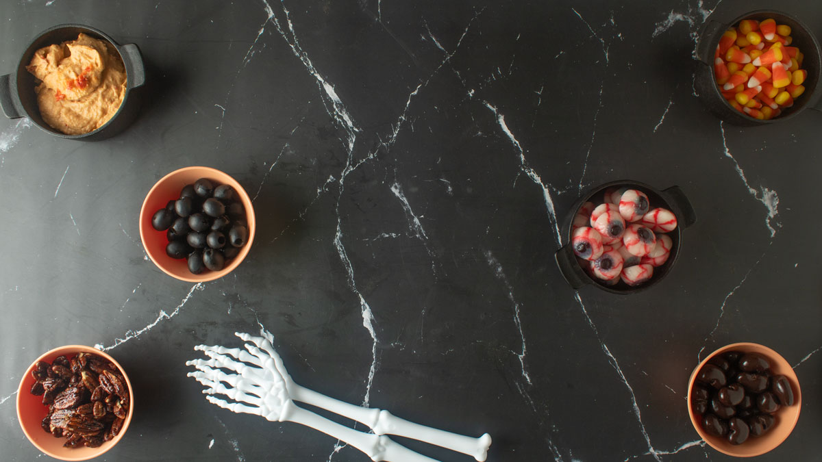 Bowls of ingredients on a black board.