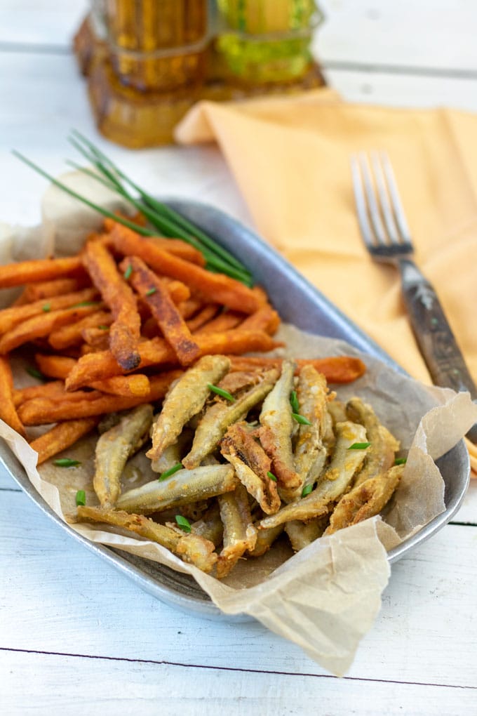 smelt with sweet potatoes on pewter bowl