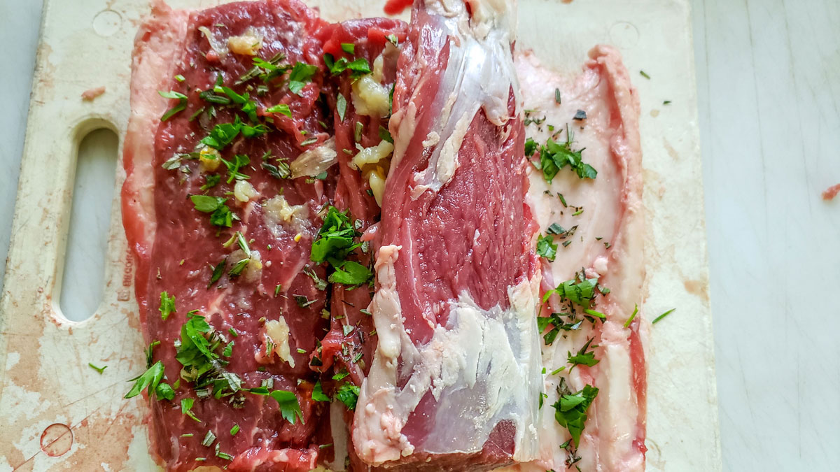 Herbs sprinkled inside the loin, also between the fat layer and the outside and the meat.