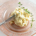 Roasted garlic butter in a pink butter dish.