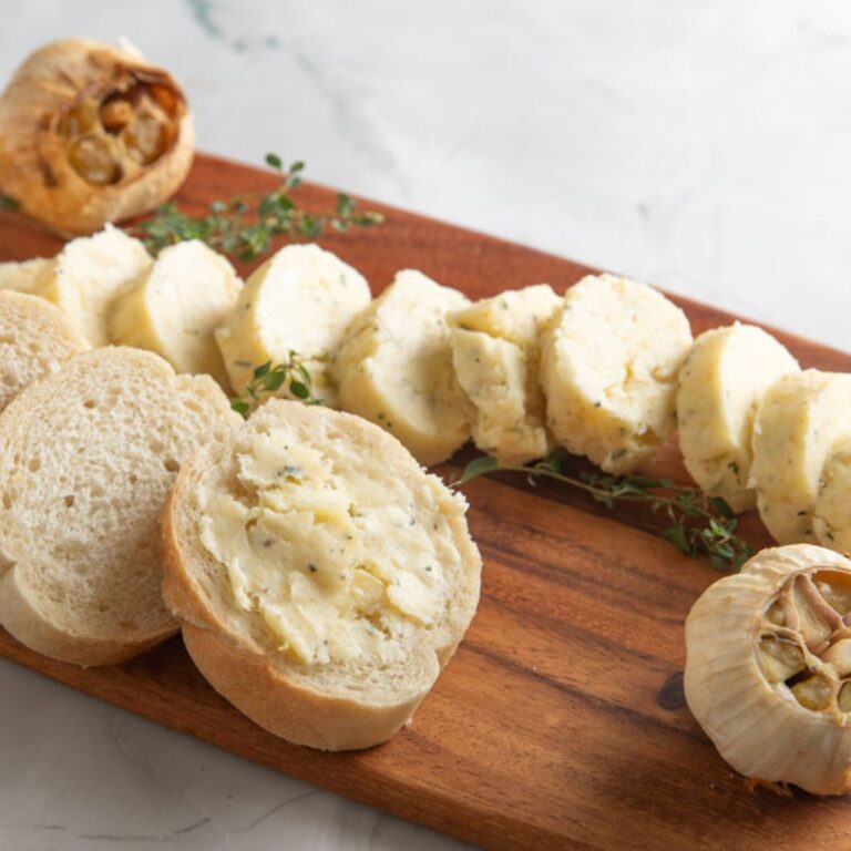 Roasted garlic butter on a slice of French bread.