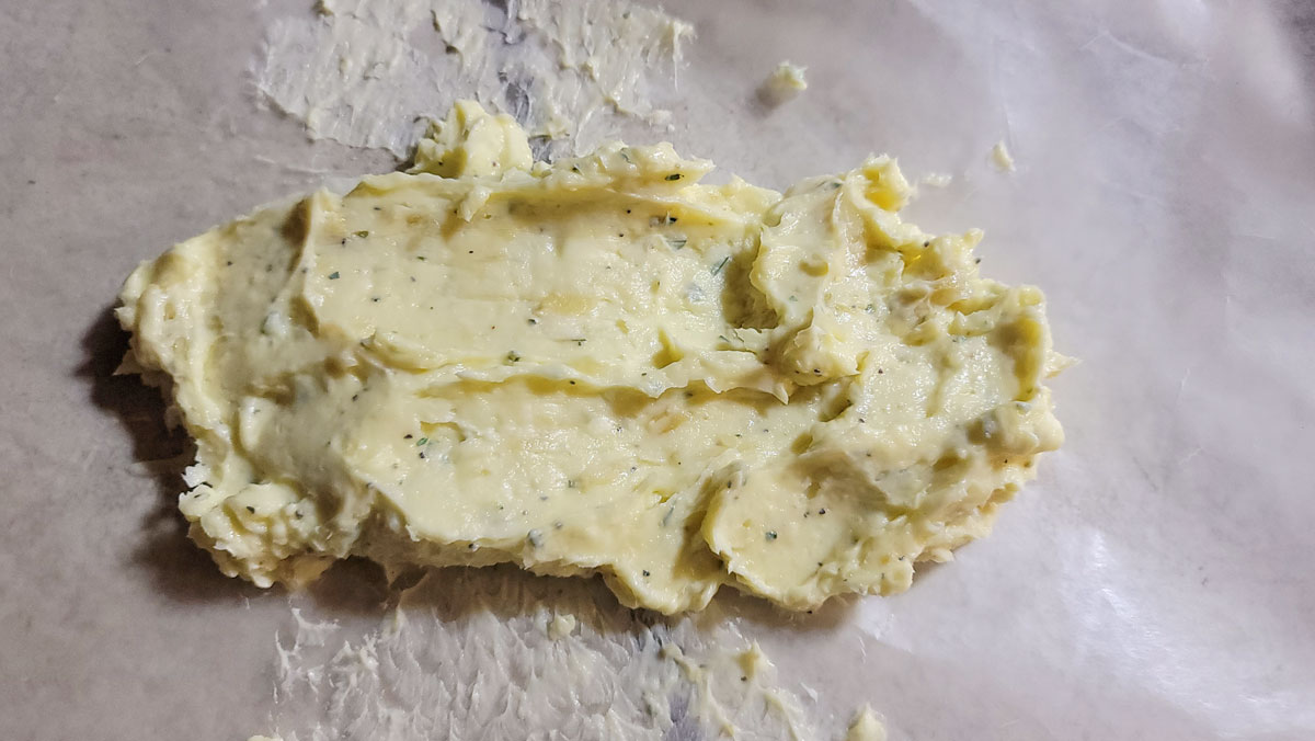 Butter spread on a sheet of waxed paper with a spatula..
