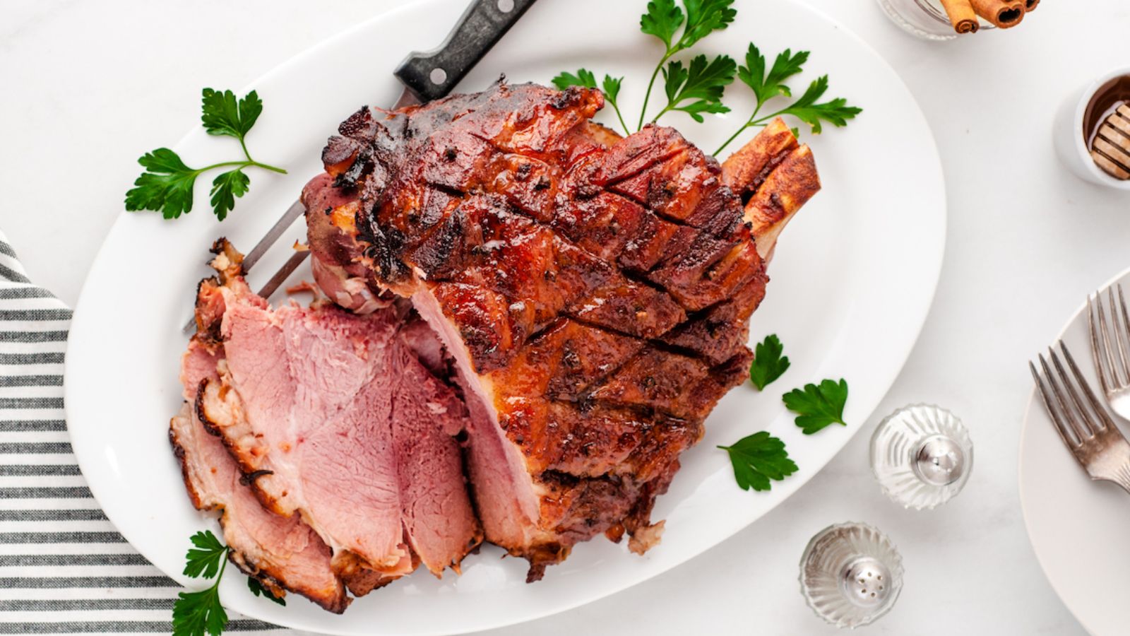 Honey glazed ham on a plate.