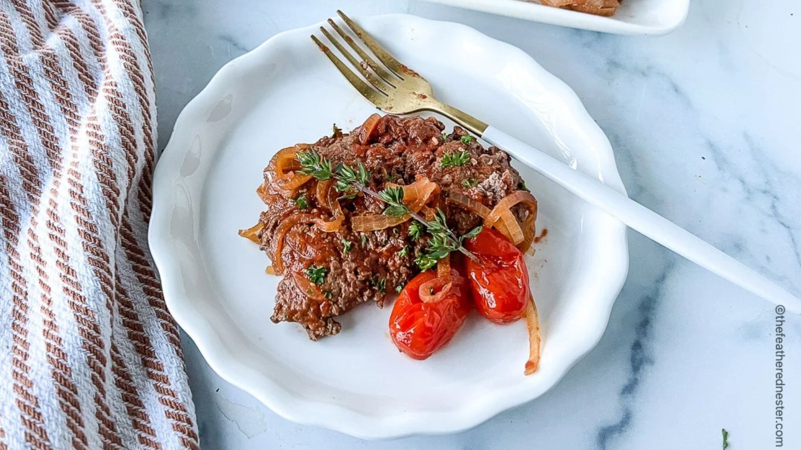 Steak with onion and cherry tomatoes.