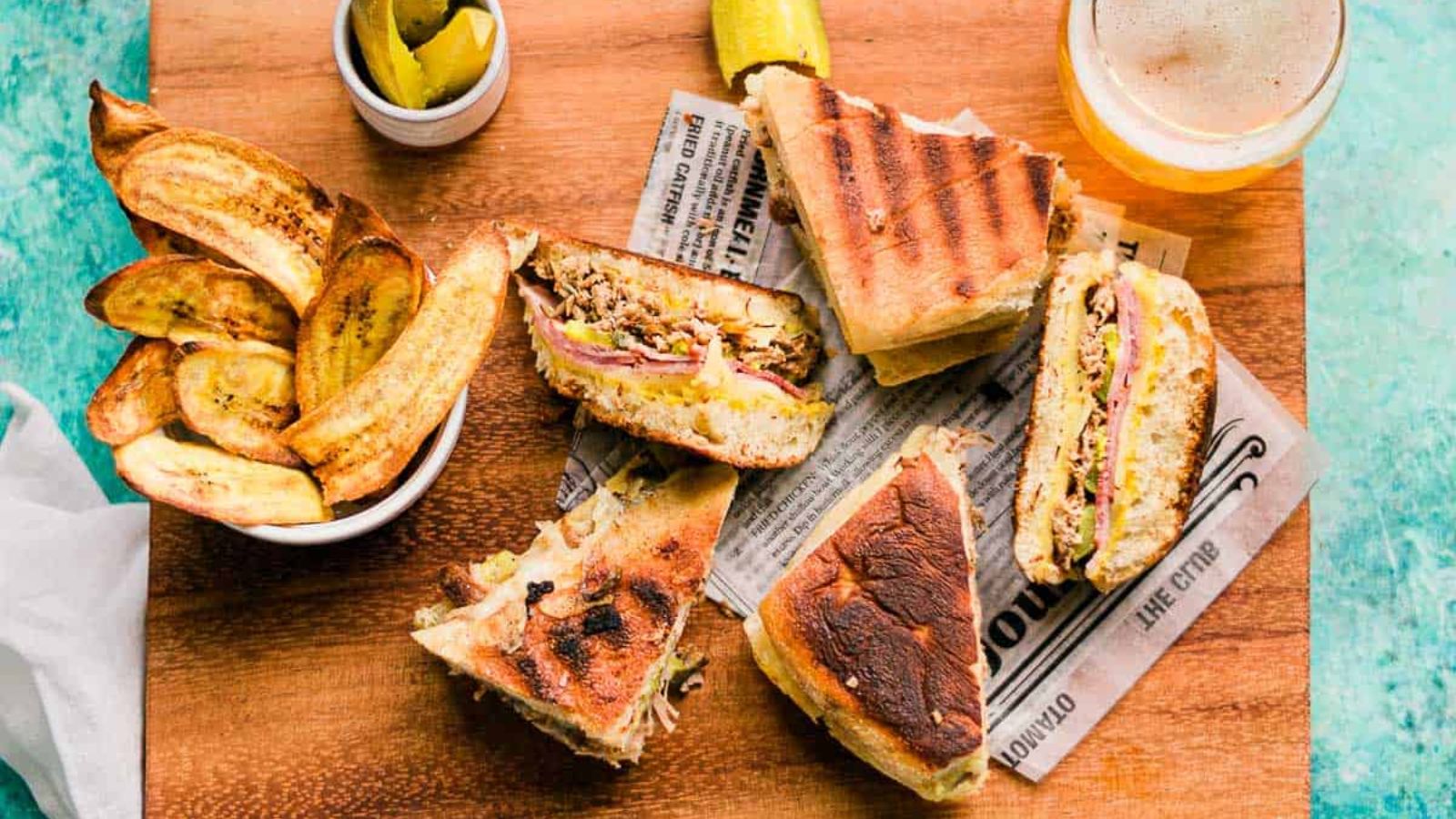 Sandwich with pulled pork on a wooden board.