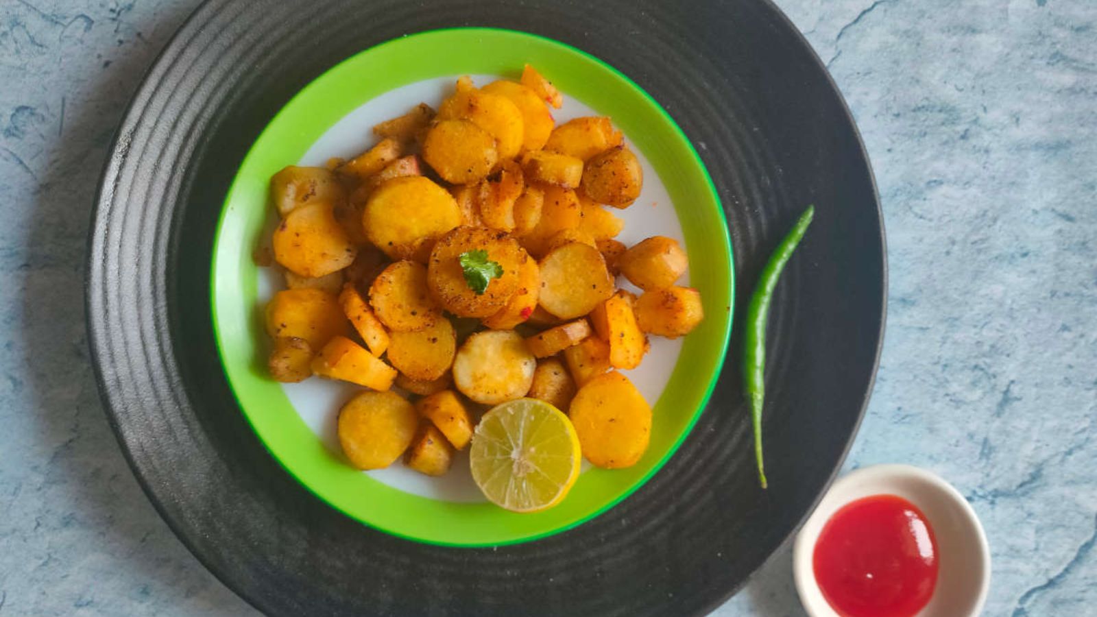 Sauteed sweet potato on  a plate with dip on the side.