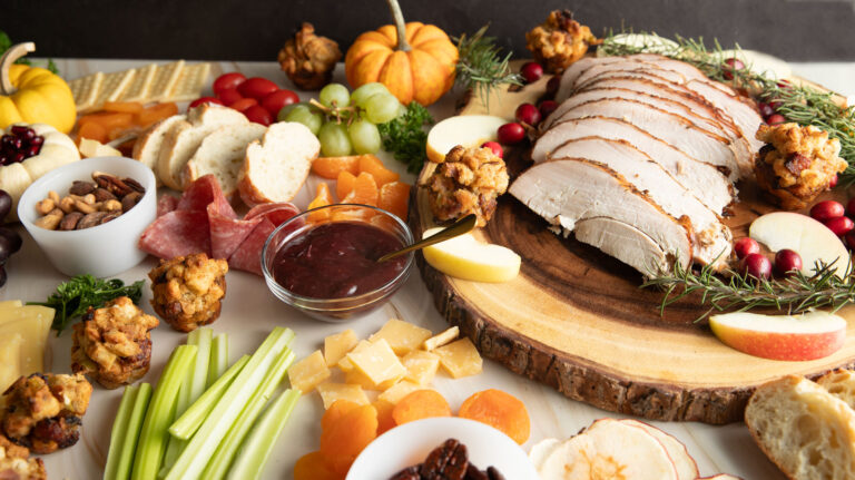 Colorful Thanksgiving Charcuterie board with turkey, stuffing and cranberries.