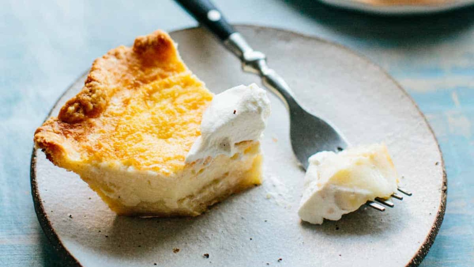 A slice of custard pie on a plate.