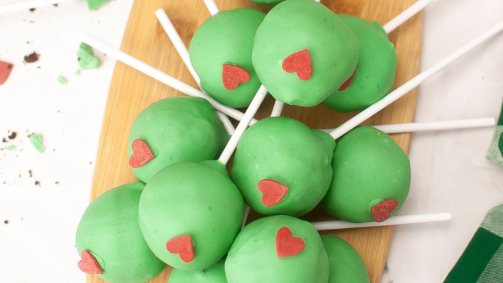 Green cake pops on a stick.