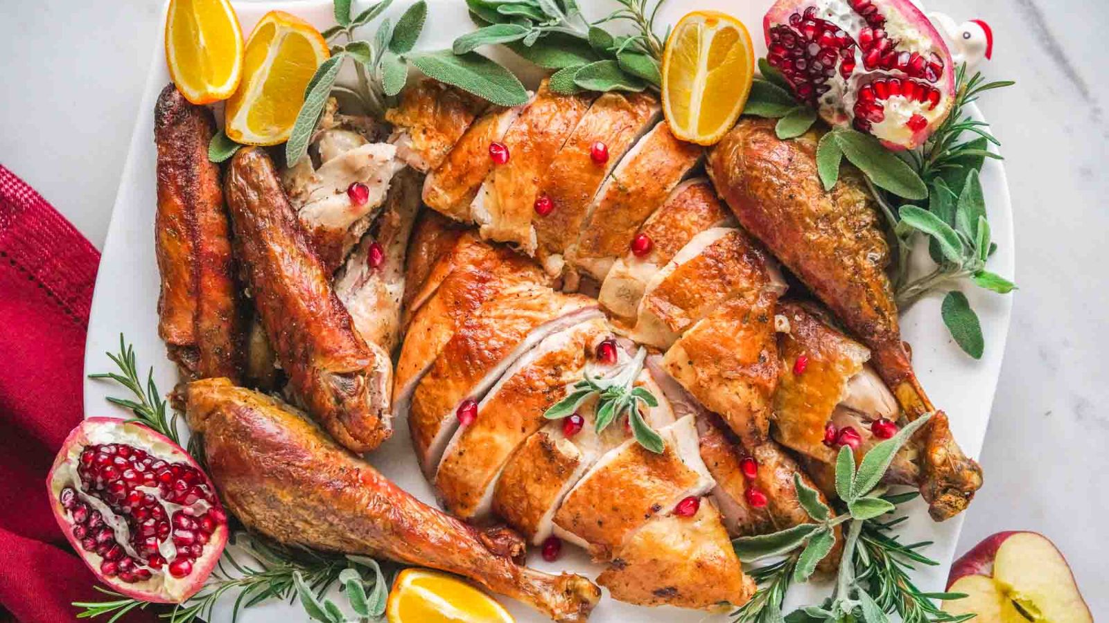 Sliced griled turkey with sliced lemons.