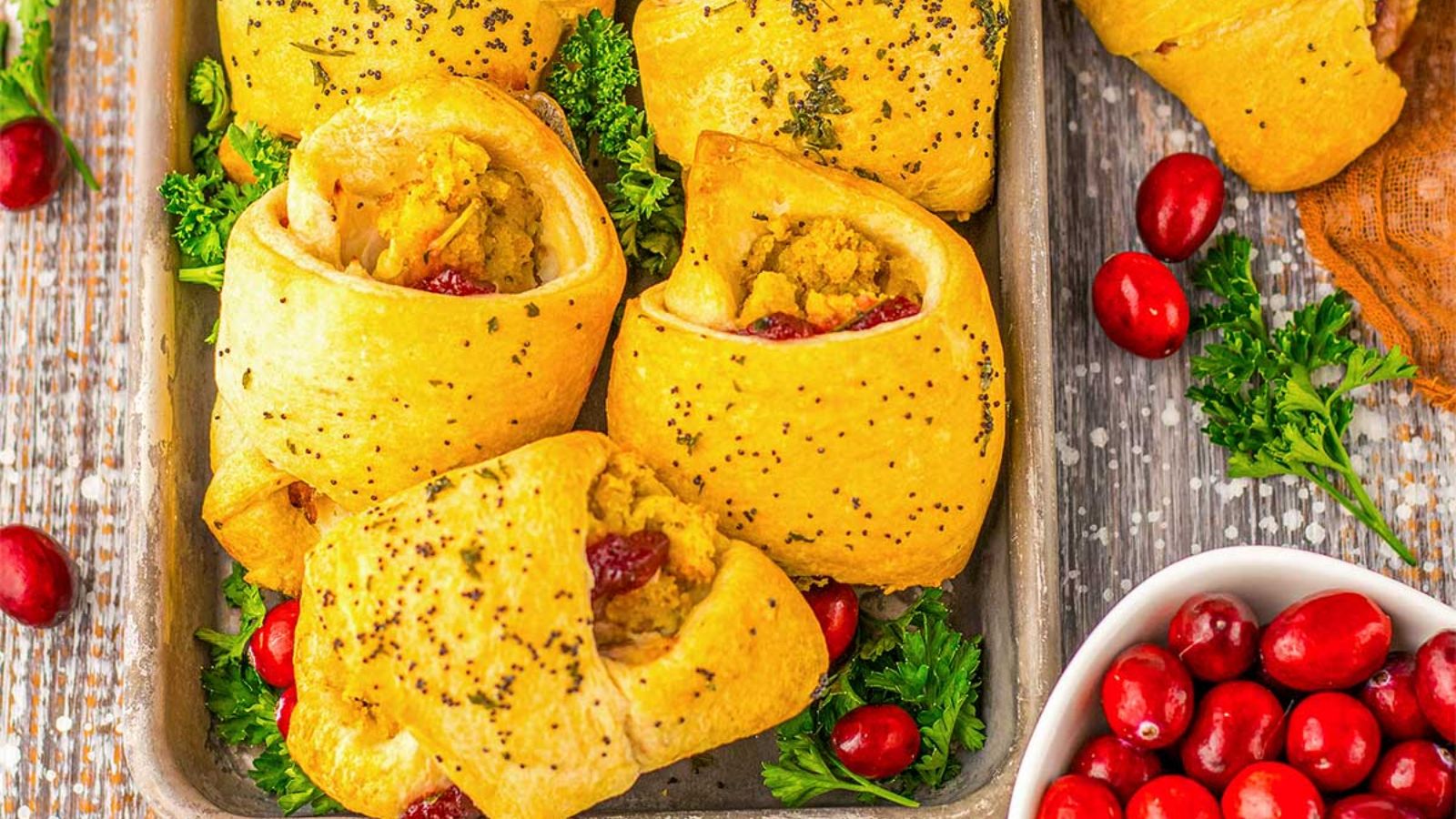 Turkey crescent rolls with cranberries on the side.