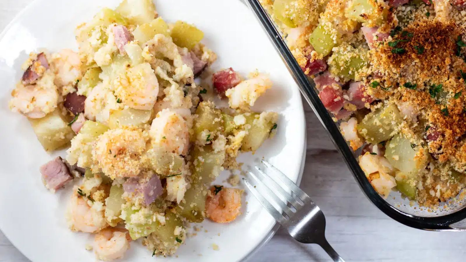 Mirliton dressing with shrimp on a plate.