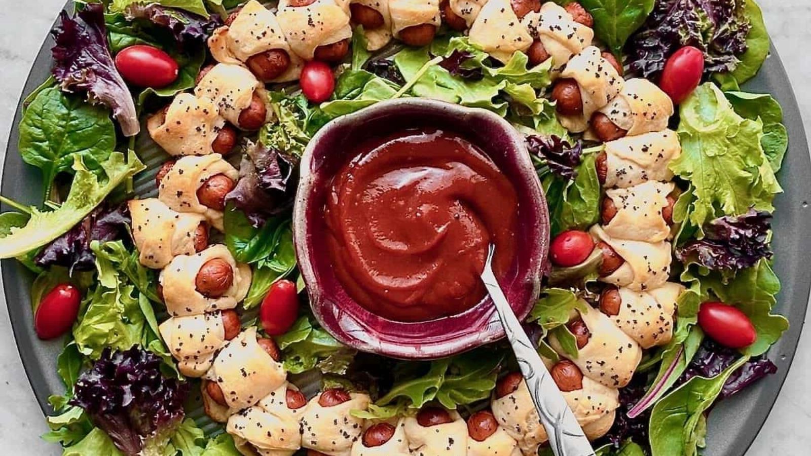 Pigs in a blanket wreath with dip.