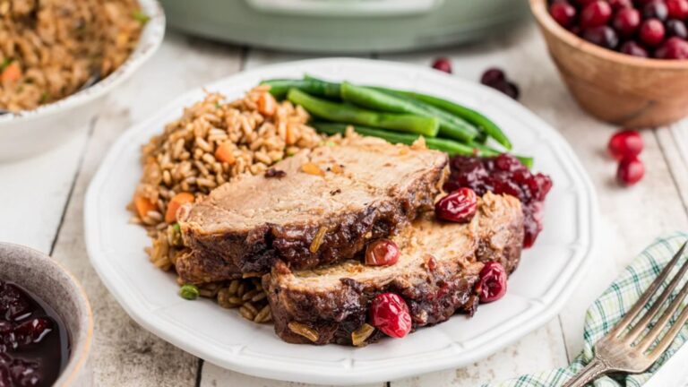 Two slices of pork loin with cranberries.