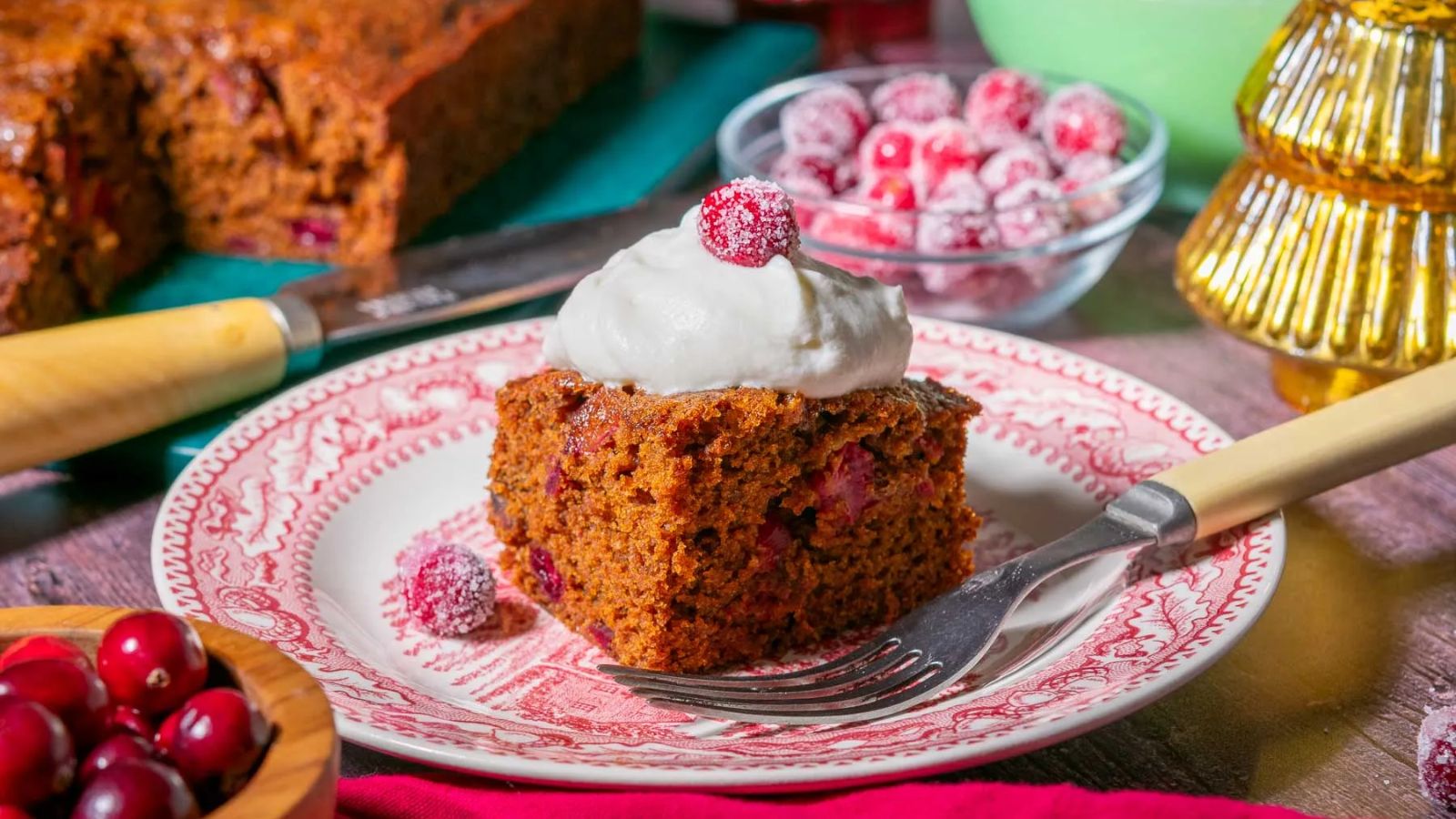 A slice of gingerbread cake with cranberries.