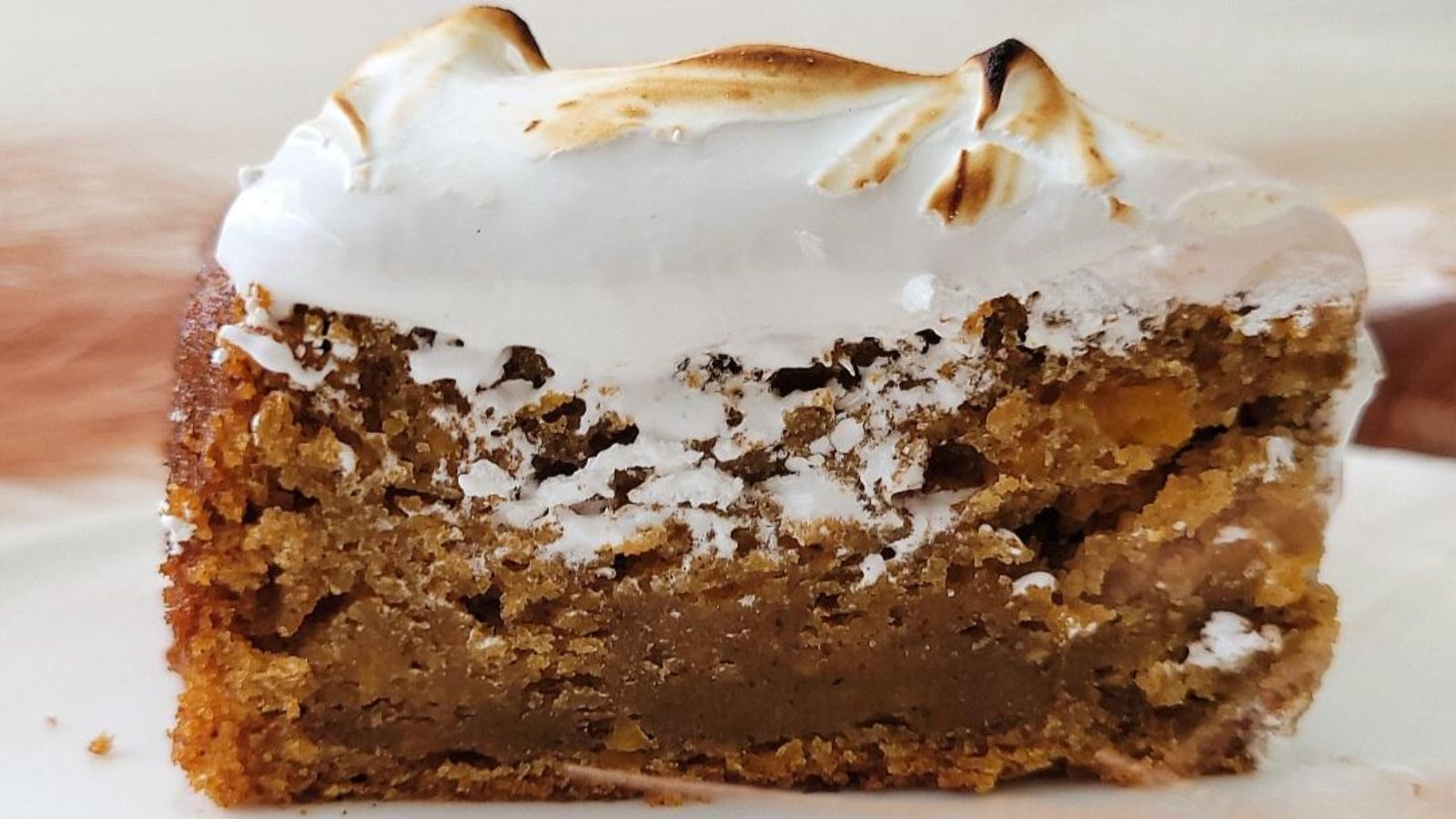 A slice of cake with marshmallow on top.