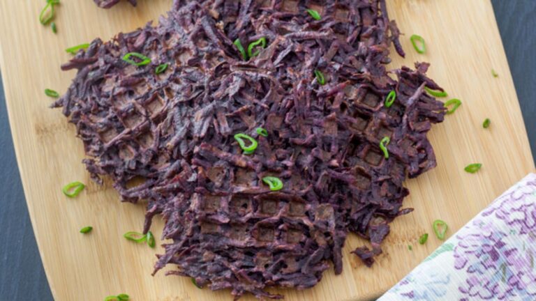 Sweet potato waffles with scallion garnish.