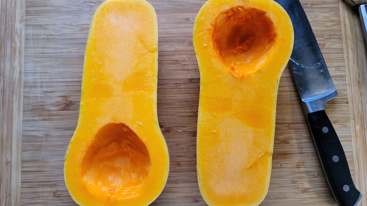 Butternut cut in half with the seeds scooped out.