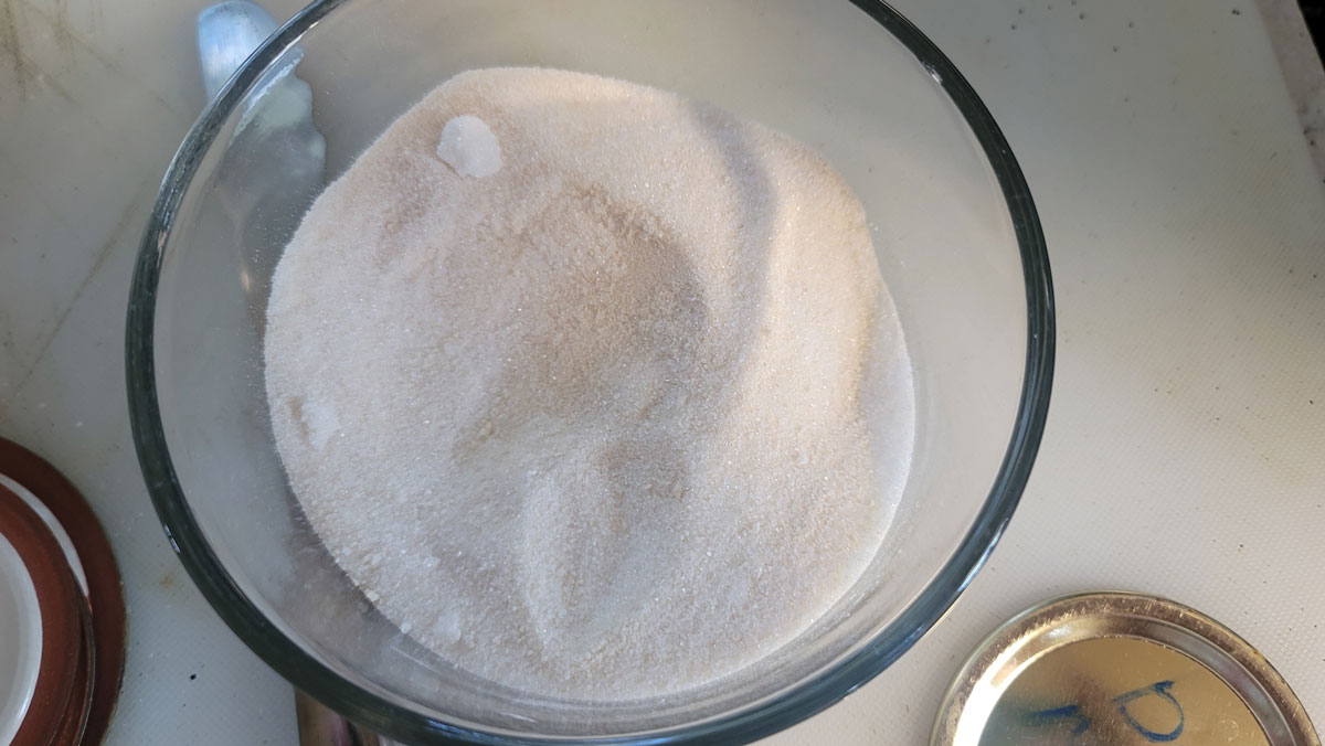 Sugar measured in a glass bowl.