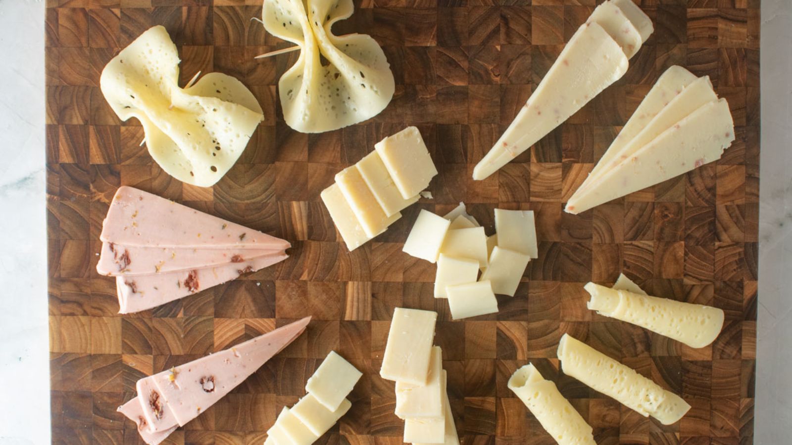 Different shapes and sizes of cut cheese.