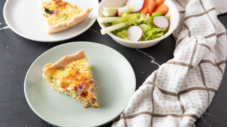 Small plates with quiche and a side salad.