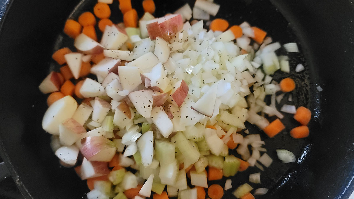 Mirepoix and apples in a large skillet.